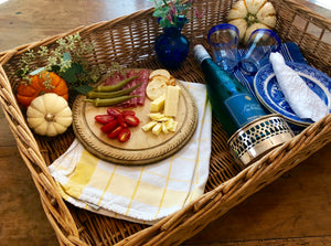 Beautiful wicker basket, bread board, silver plate wine coaster and Blue Willow plates. 